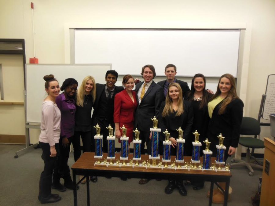 The forensics team posing with trophies acquired during the 2013-2014 season.
(Photo courtesy of Suffolk University)