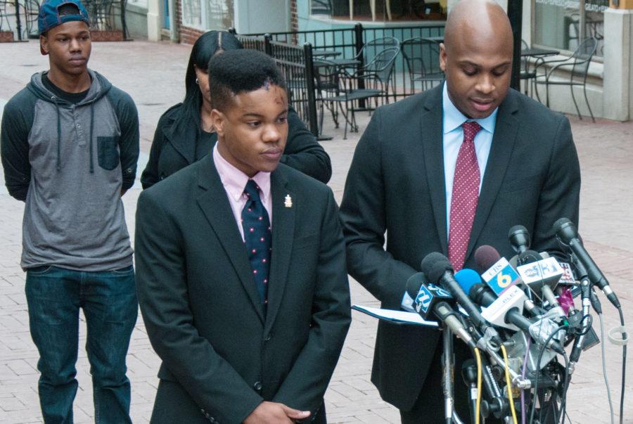 Martese Johnson stands next to his lawyer as he reads a statement to the media.
By Flickr user Bob Mical