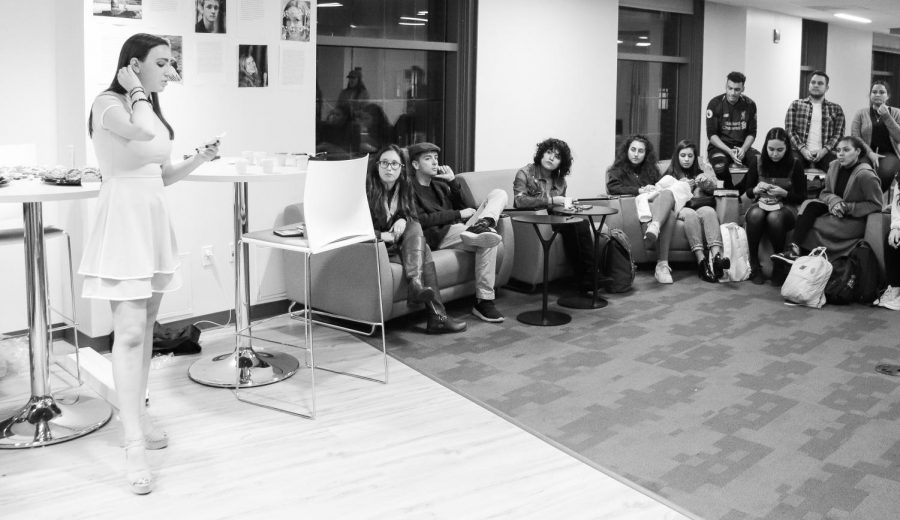 (From Left) Casey Grosjean, president of both Suffolk University’s Healthy Minds Alliance and Suffolk University’s Photography Club, speaks to the auidence at “Share Your Story” event on Wednesday. 