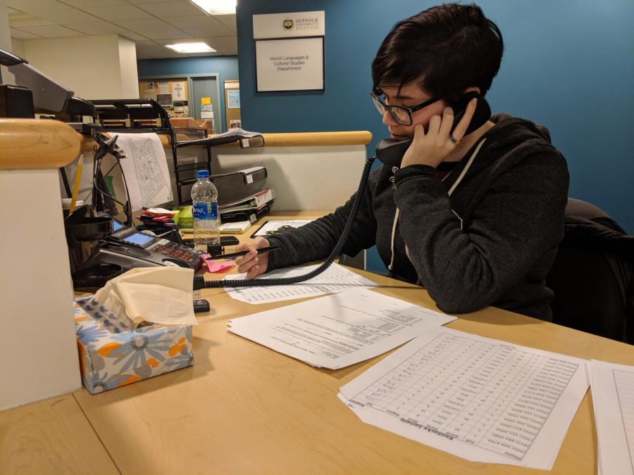 Suffolk graduate student Marissa Dakin calls one of hundreds of phone numbers to complete the class survey. 