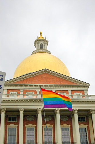 A rainbow Pride flag flies in front of the Massachusetts State House in Boston