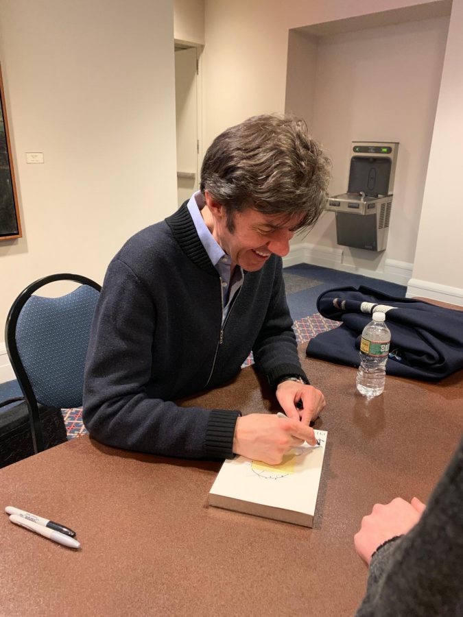 Stefan Sagmeister autographing books inside Sargent Hall