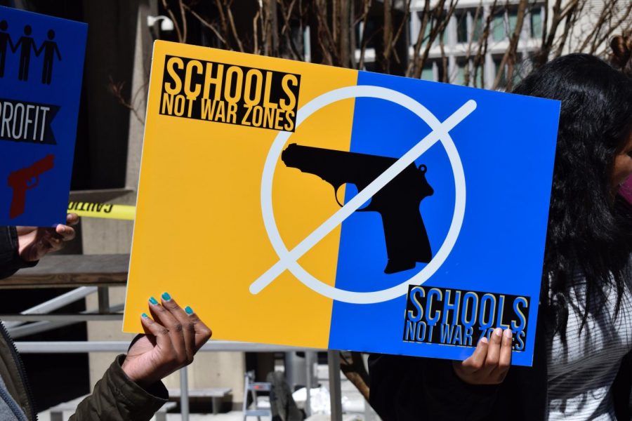 Student protestors raise hand designed posters 