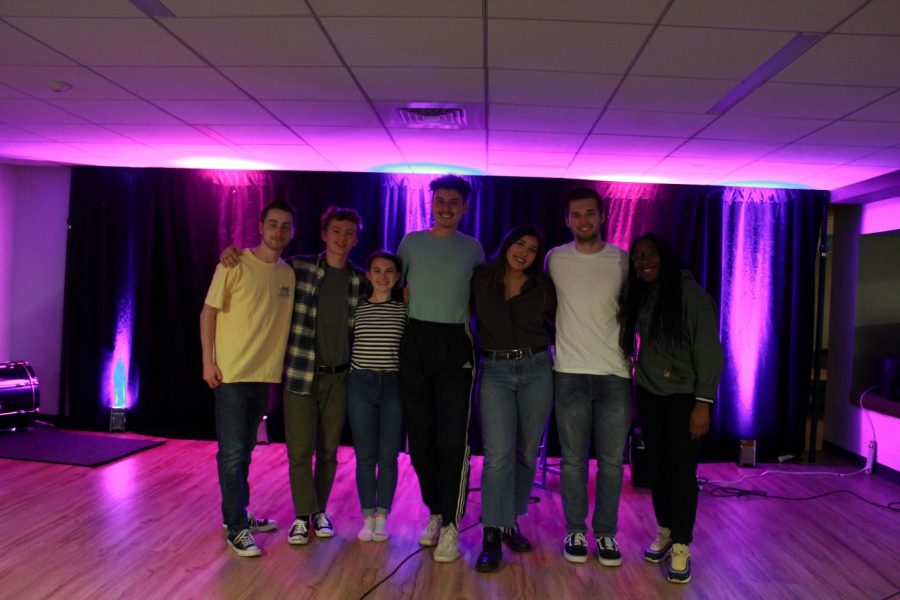A group of musicians and music fans pose at the club’s last open mic event of the semester on Friday