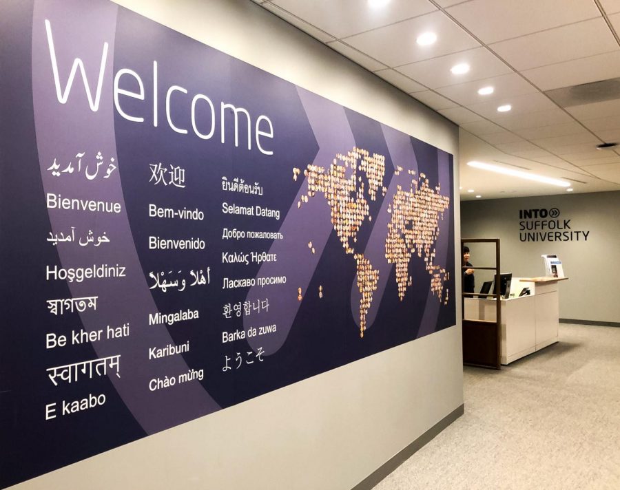 A wall with welcome written on it in different languages at Into Suffolk University. 