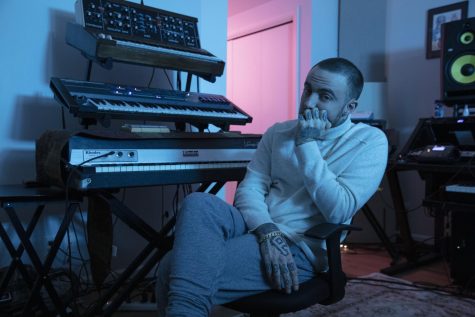 Miller contemplates in front of the keyboard in the studio