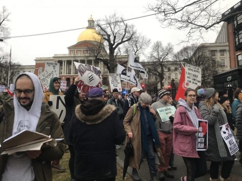 Protesters gather in front of the Massachusetts State House steps to begin marching against conflict with Iran