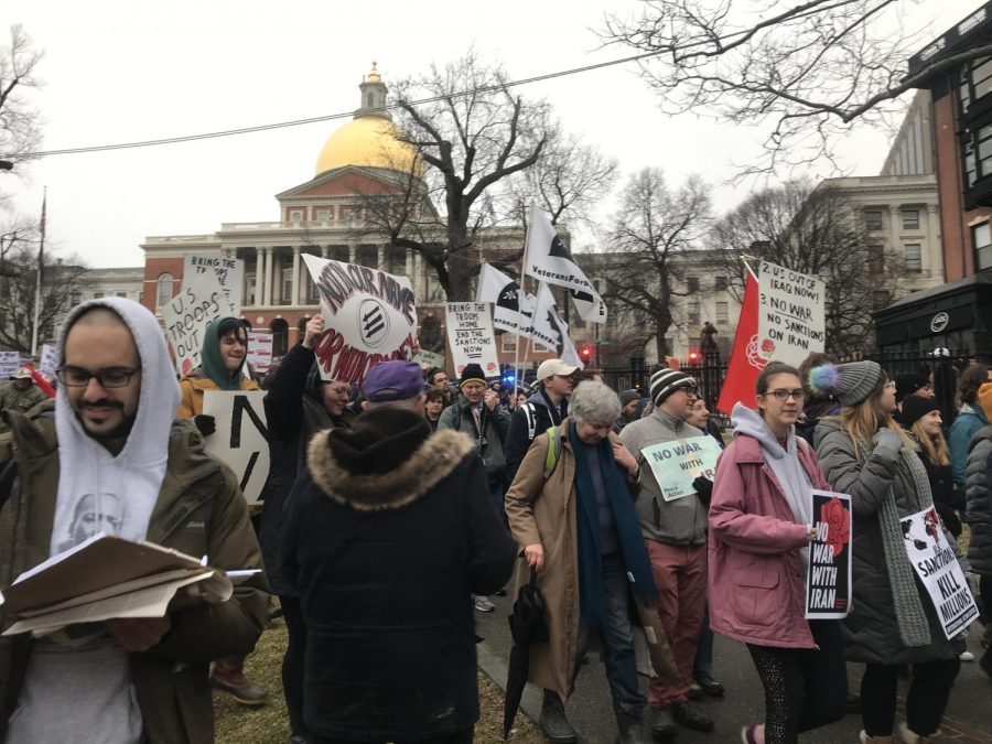 Protesters gather in front of the Massachusetts State House steps to begin marching against conflict with Iran 