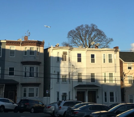 A row of apartments line an East Boston street