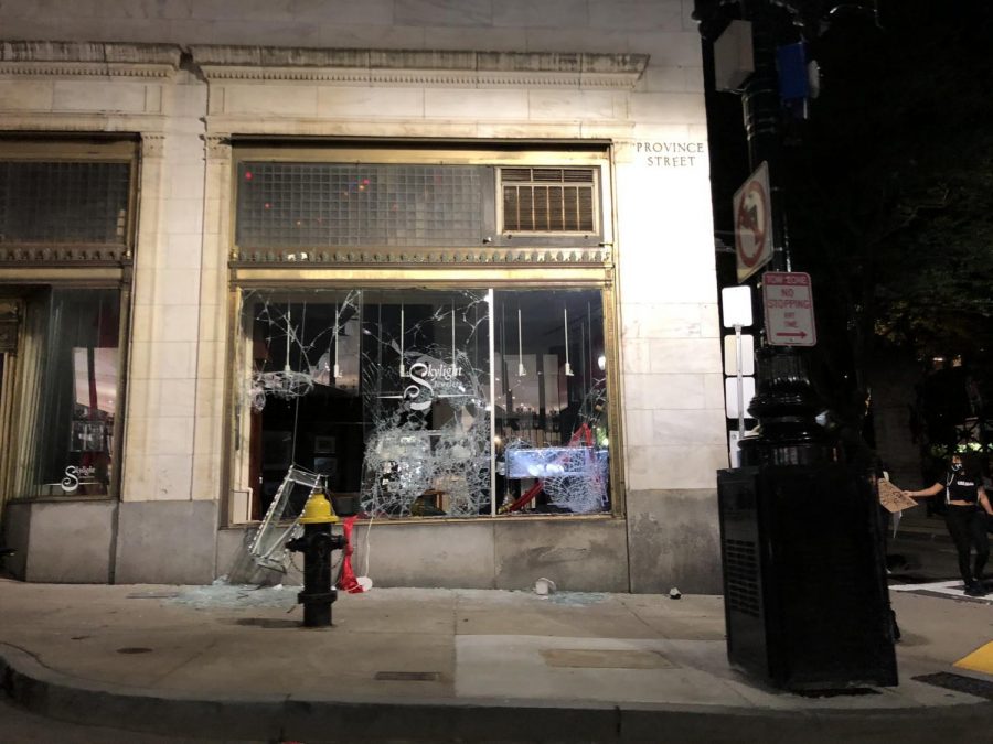 Protesters damaged the windows of a business near the old Boston City Hall Sunday nights. 