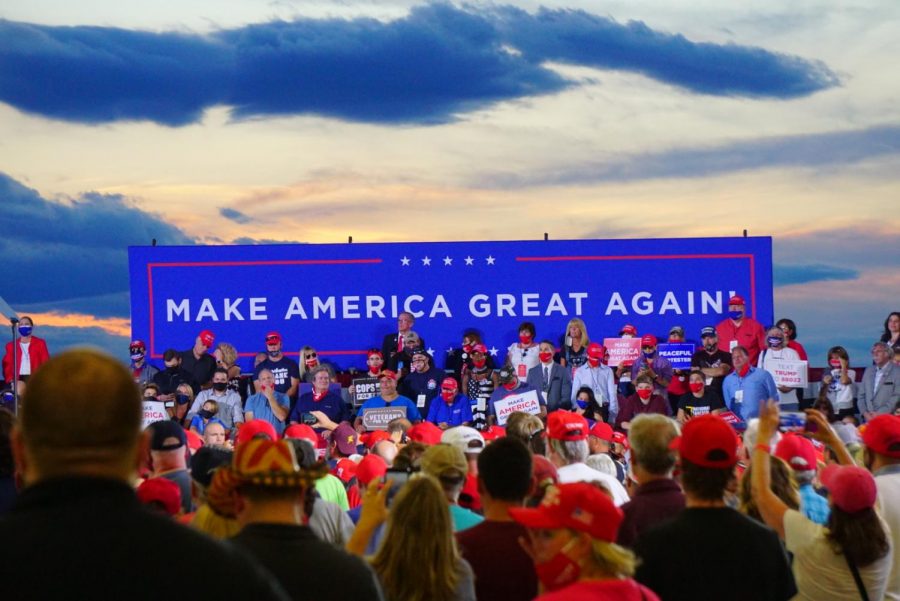 Trump supporters sit on risers at a Trump rally in Londonderry, N.H., in summer 2020. 