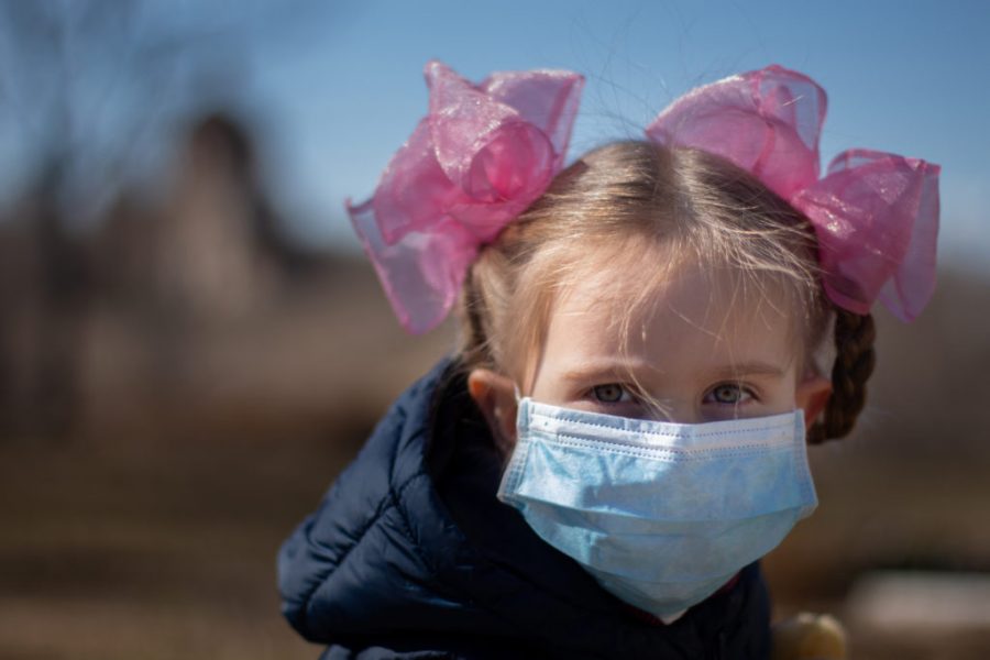 A young child wears a mask amidst coronavirus pandemic.