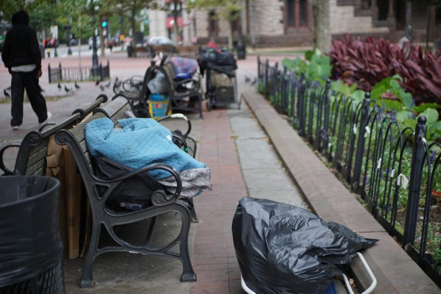 A person sleeps on a bench in Copley Square
