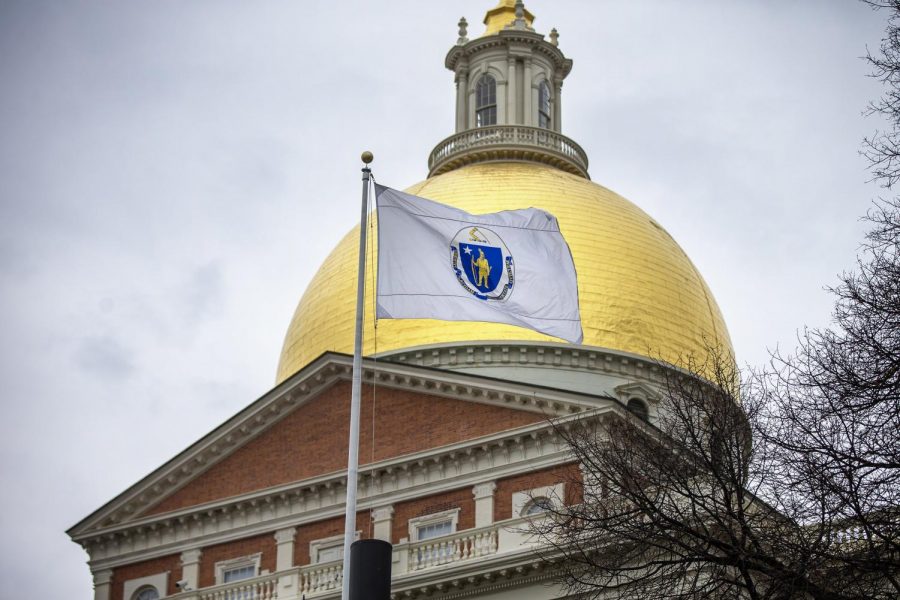 Massachusetts flag containing Native American imagery flying outside of the State House. 