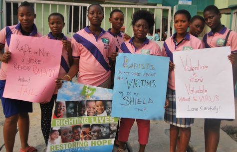 Women hold posters advocating against rape.
