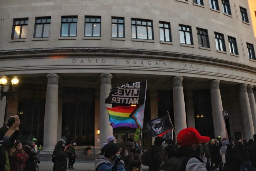 Demonstrators march outside of Suffolk Universitys Sargent Hall at 120 Tremont St.