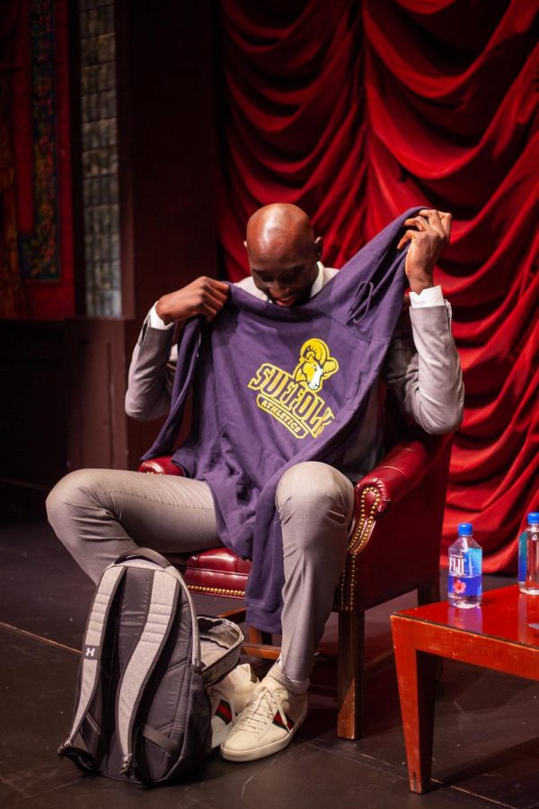 Tacko Fall holds up his new Suffolk Rams sweatshirt in Modern Theatre on Sept 11