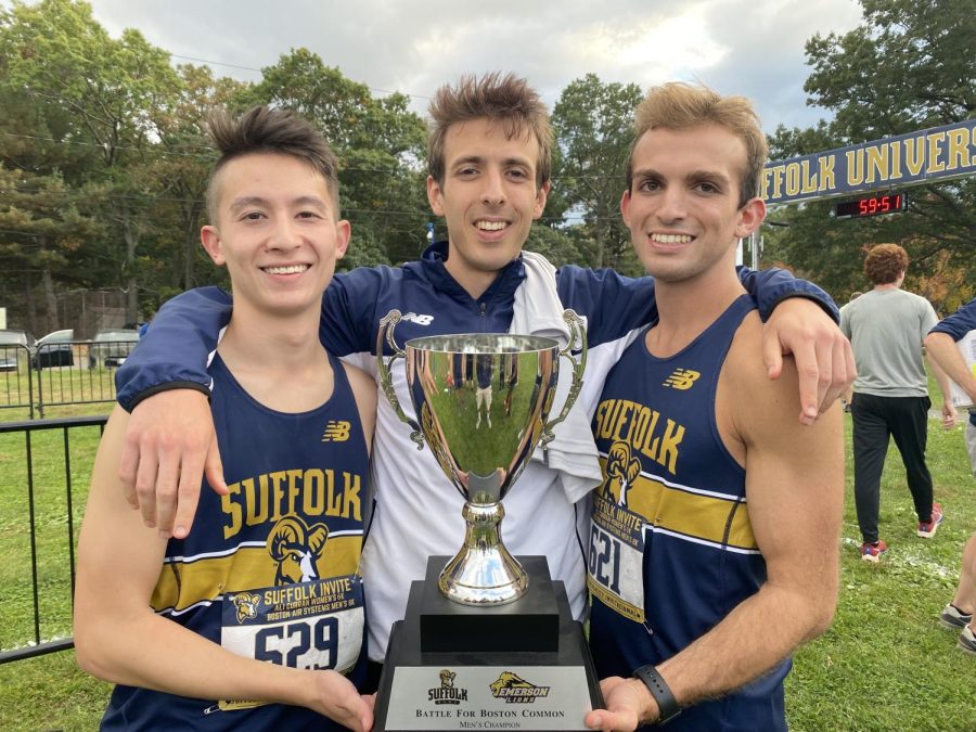 Mens cross country captains Hunter Toyoda, Matyas Csiki-Fejer, and Nic Malm pose with the Battle for the Common Trophy