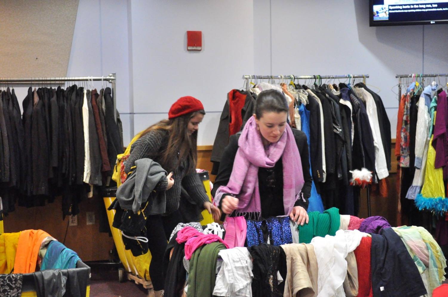 Two girls shop at a past thrift sale for the Performing Arts Office. The annual sale returns for the first time since the pandemic on Oct. 19 and 20.