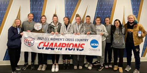 Members of the womens cross country team and head coach Will Feldman pose with their new championship banner on Saturday after becoming CCC champions