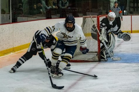 Sophomore Kyle Valiquette plays a puck during the Rams win over Nichols.