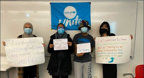 Four Suffolk UNICEF members created signs to spread domestic violence and child marriage awareness. 