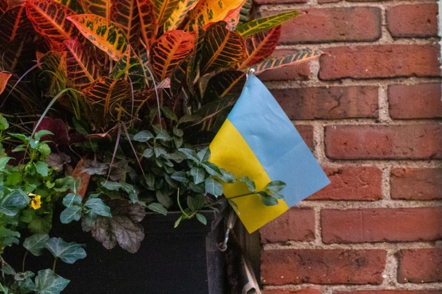 Ukrainian flag sits in bed of flowers in Beacon Hill. 
