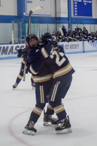 Stephanie Moy and Jessie Kennedy celebrate a goal during a matchup against UMass Boston last year.