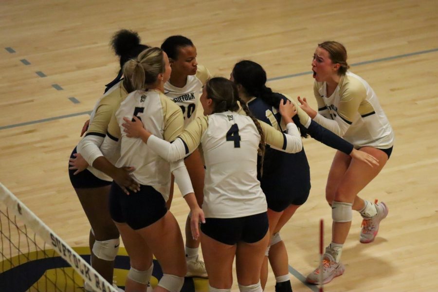Volleyball celebrates after scoring a point against Salve Regina.