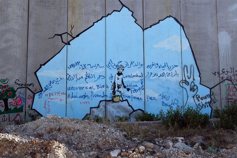 A barrier in the West Bank was painted by British graffiti artist Banksy.