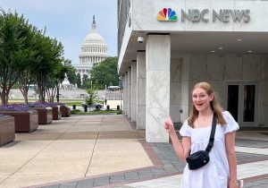 Stanton points at the U.S. Capitol outside of NBC News. Courtesy of Shannon Stanton