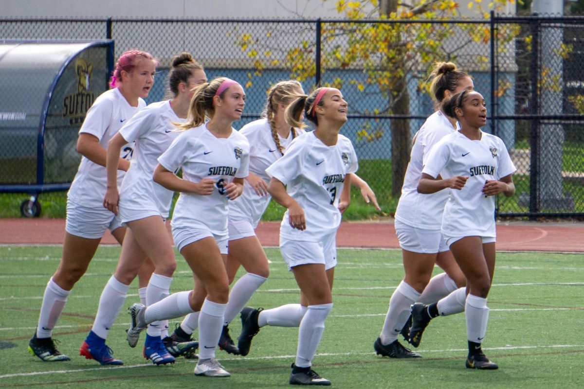 Suffolk womens soccer team celebrates a goal from a game against Nichols in 2021