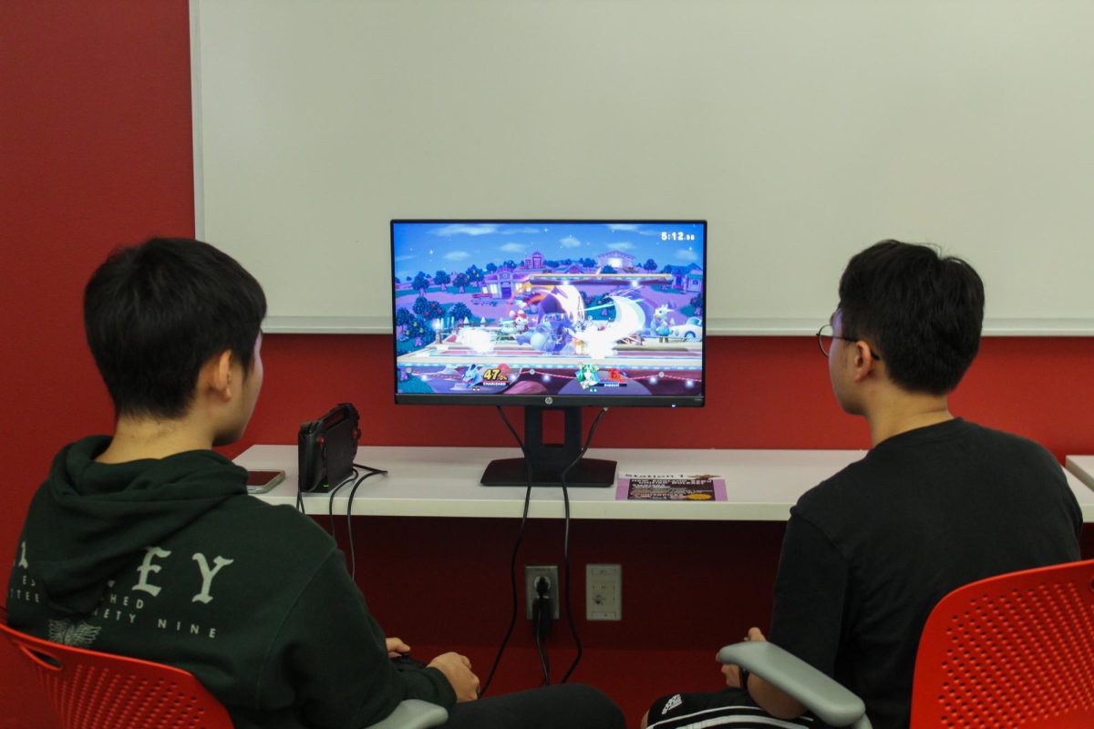Two students play Super Smash Bros. at the tournament. 