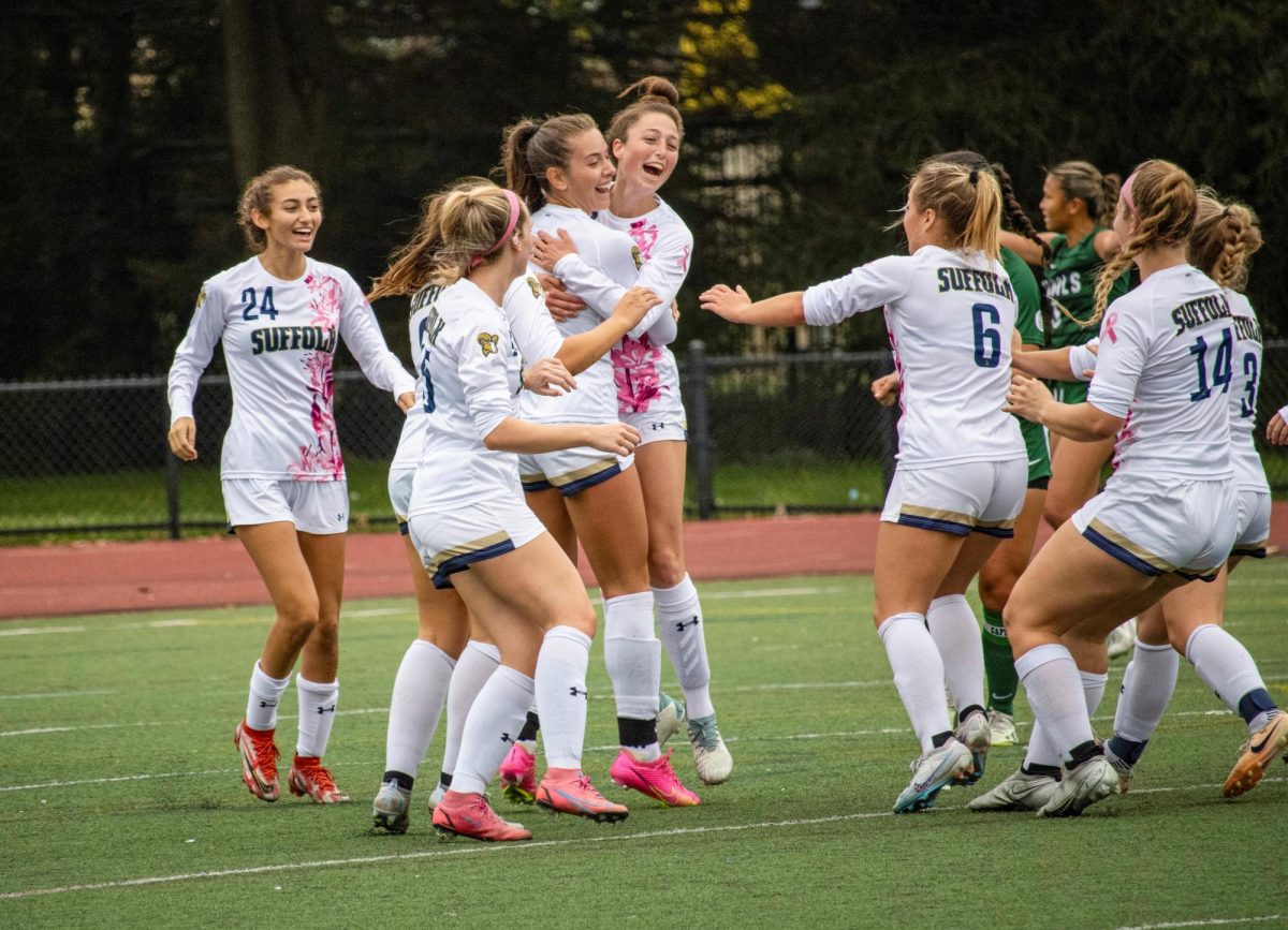 The Suffolk University womens soccer team celebrates a goal against Nichols College. The Rams won the game in an 8-1 blowout Oct. 7.