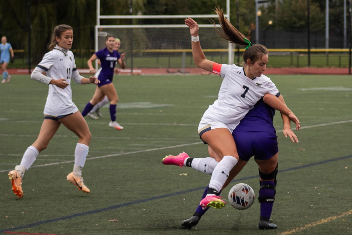 Senior forward Klaudia Rushi trips while going for the ball in a 1-1 draw against Curry College Oct. 14.