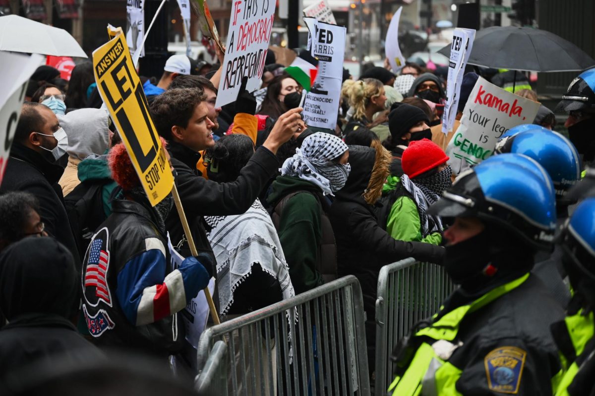 Protesters line Boston streets as police set up barricades due to crowd size.