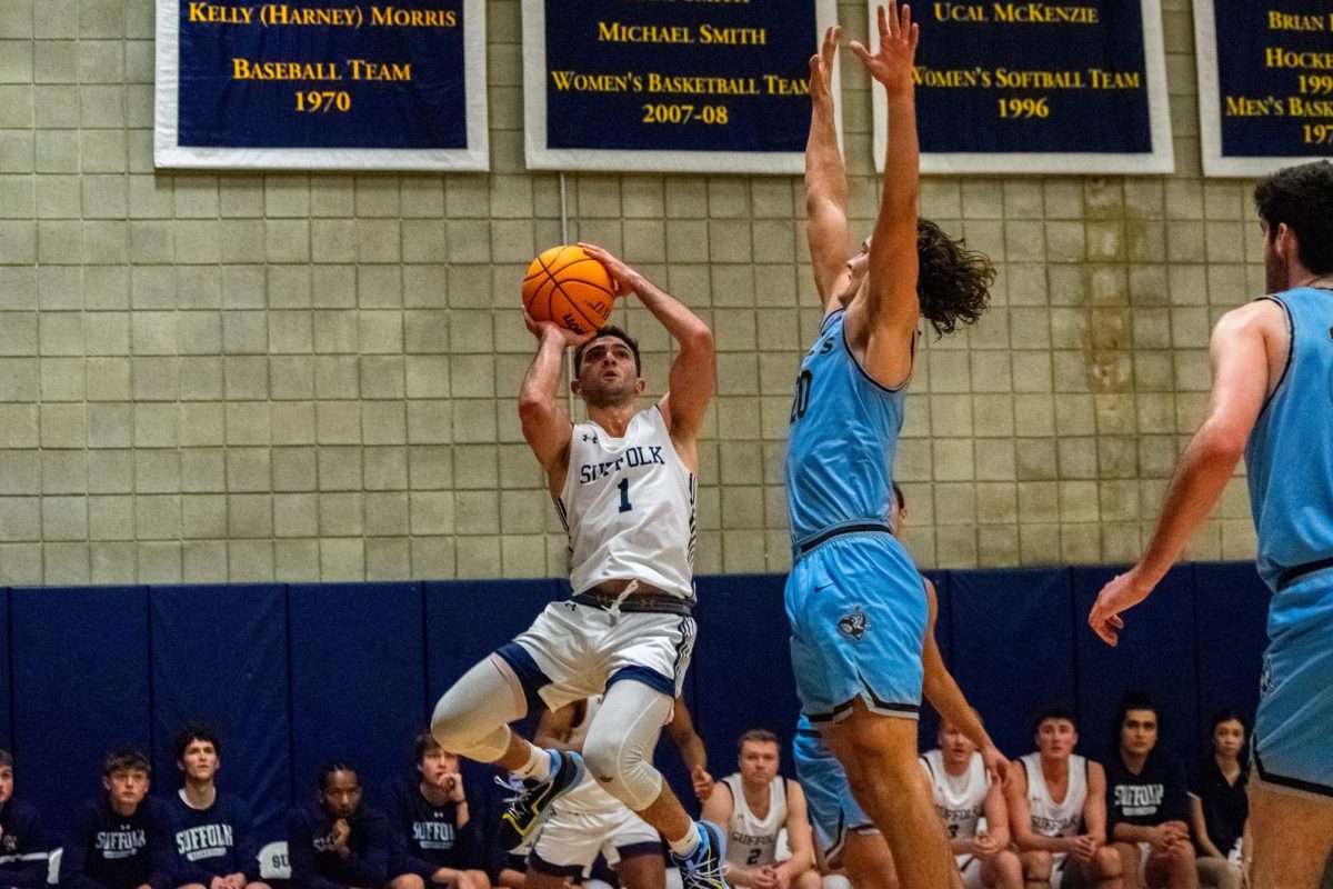 Graduate student guard Danny Yardemian takes a contested jump shot. Yardemian set a career high in points (17) and free throws made (4) in a 76-62 loss against Tufts University at Smith Court Nov. 17.