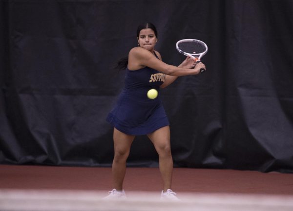 Senior Caren Urbano winds up to hit the ball during a match against Salve Regina University on Oct. 8, 2022.