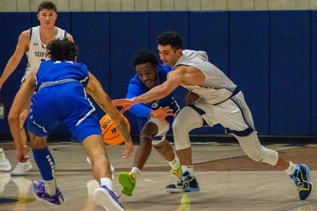 Graduate student Danny Yardemian jostles with a defender for a loose ball during a game against Colby-Sawyer college Nov. 15.