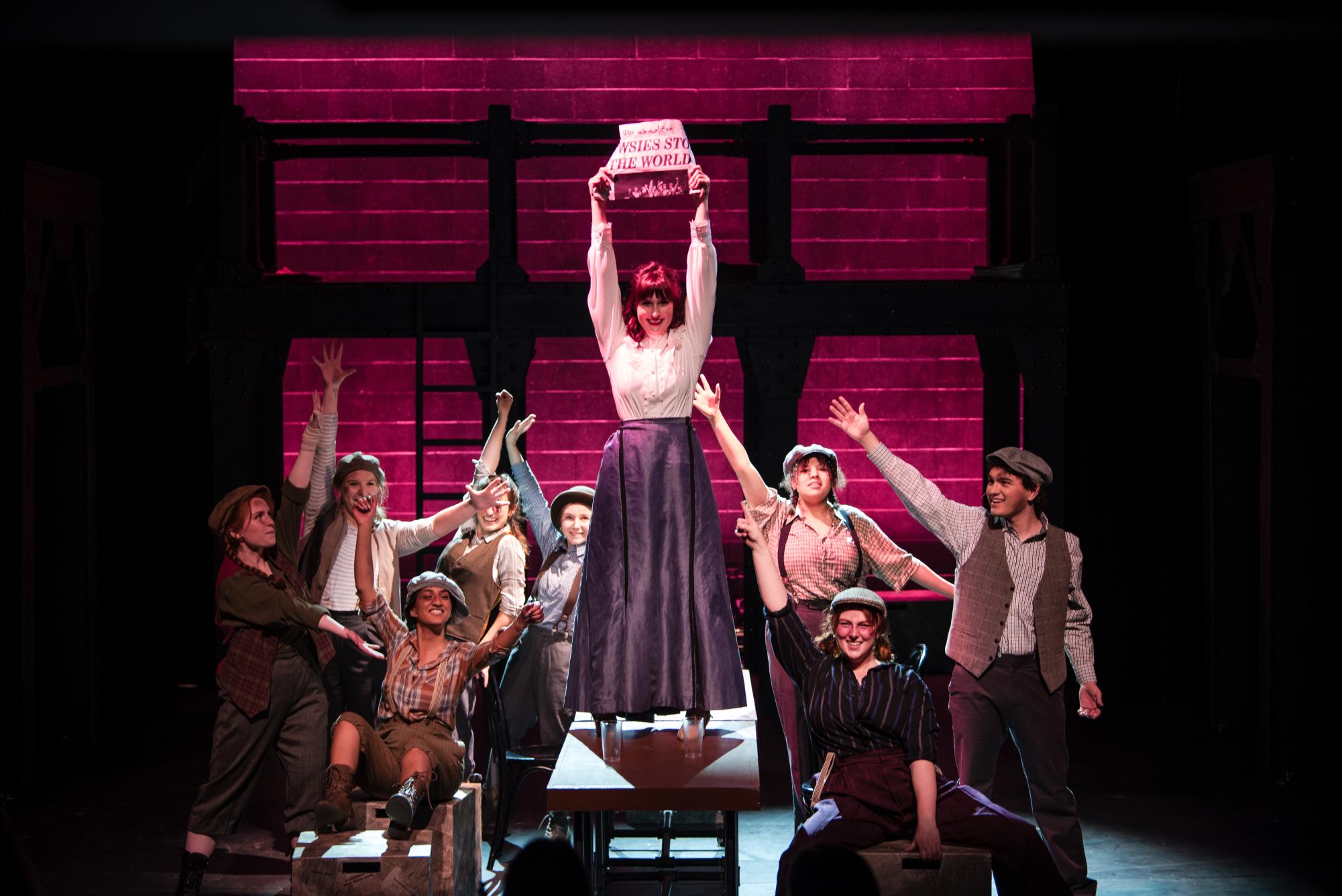 The cast of “Newsies” shines on stage during their production. 