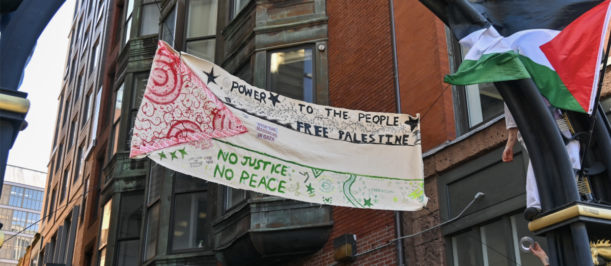 A banner painted and hung by protesters at the Popular University Encampment outside of Emerson College on April 20.