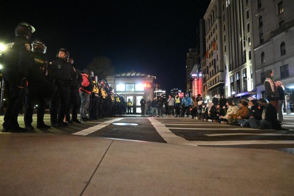Protesters form a defensive line opposite Boston Police officers on Tremont Street April 25. Boston Police made 118 arrests at the Emerson Popular University Encampment.