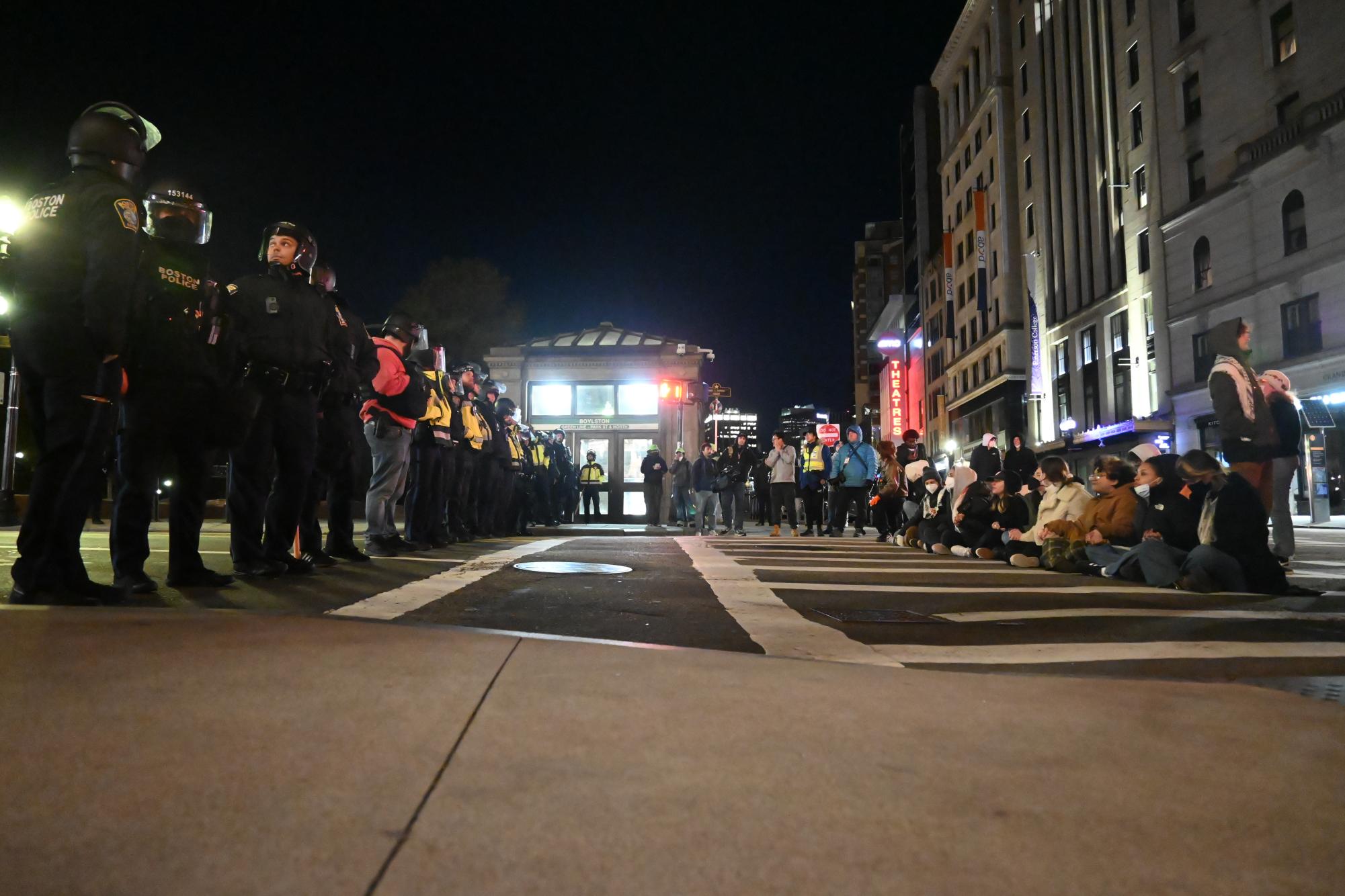 Protesters form a defensive line opposite Boston Police officers on Tremont Street April 25. Boston Police made 118 arrests at the Emerson "Popular University Encampment".