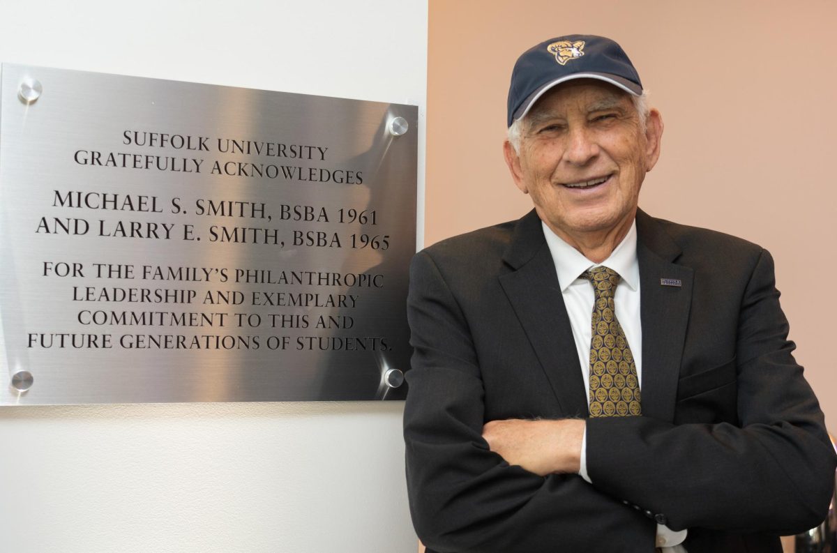 Larry Smith, BSBA '65, poses in the Smith Commons on the fifth floor of Sargent Hall.