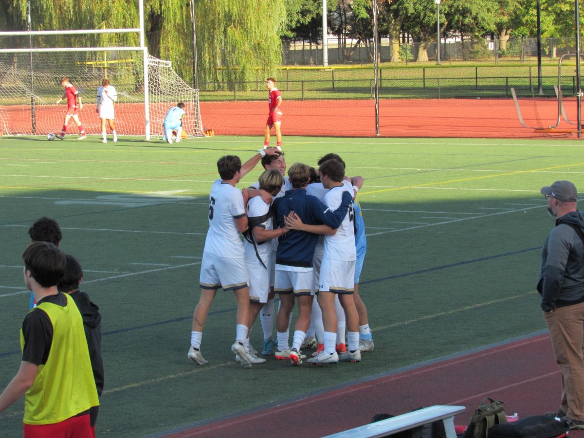 Members of the men’s soccer team celebrate after forward Francisco Valck’s goal Oct. 5.