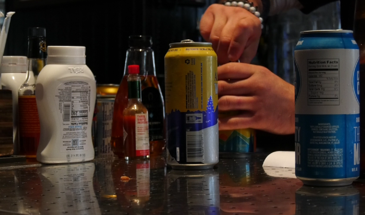 A bartender at Beantown Pub serving drinks.