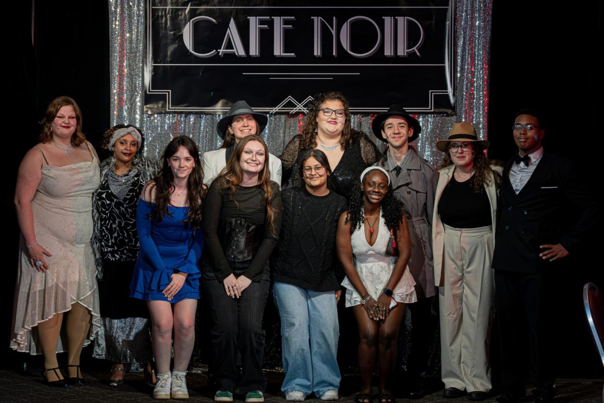 The cast of 'Murder at Cafe Noir' posing at the end of one of their performances.