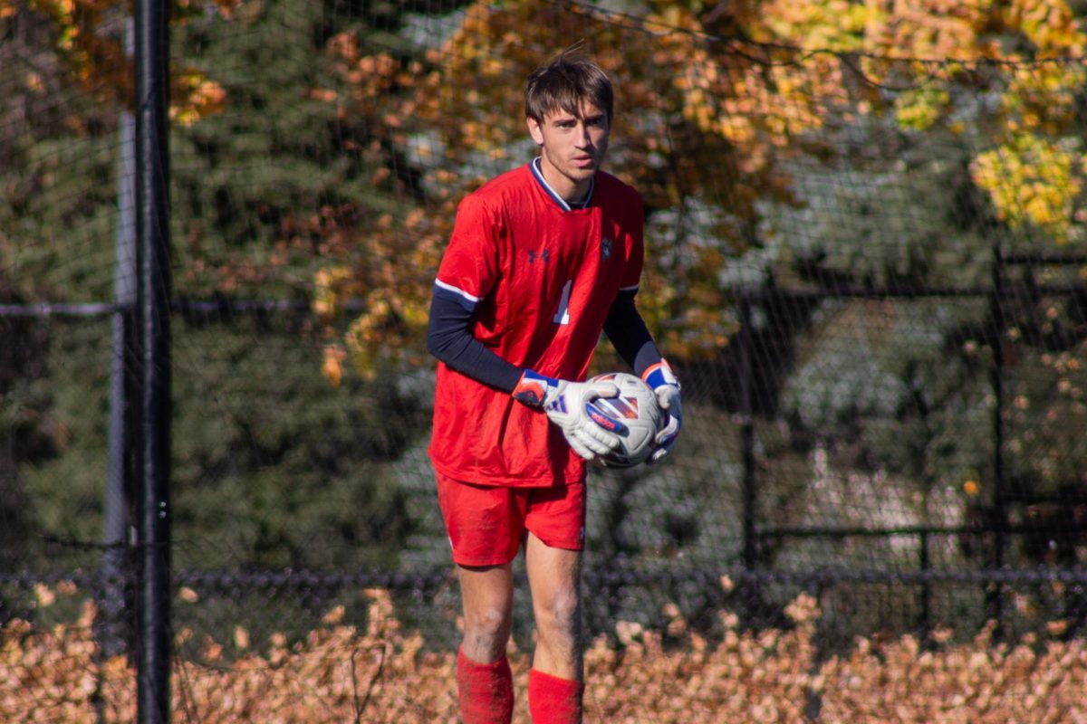 Sophomore goalkeeper Nathan Harlow holding the ball during the Conference of New England championship game.