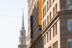 Suffolk University's academic and administrative building at 73 Tremont St. Suffolk laid off 35 staff members this summer.