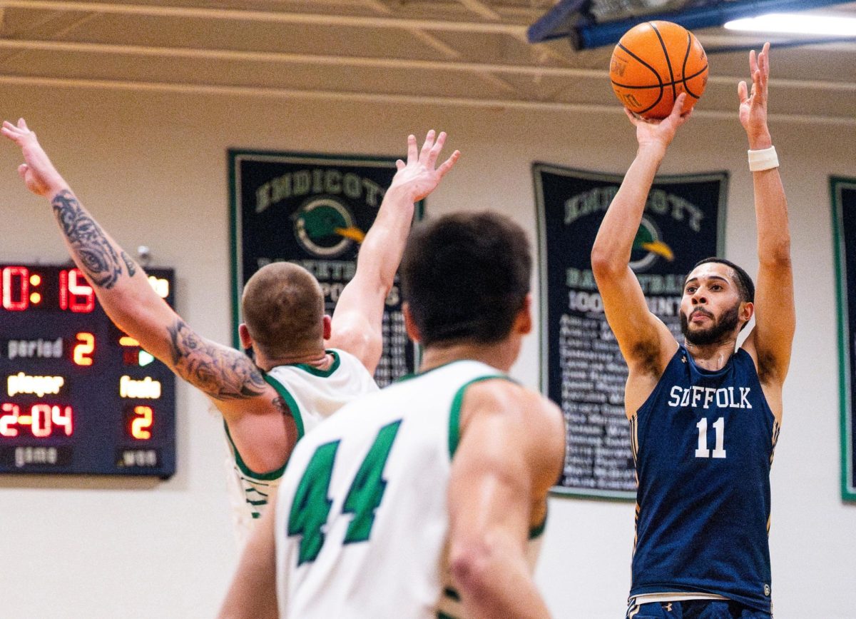 Keenan Robertson shoots the ball during a first-round playoff game against Endicott in 2024 (courtesy of Suffolk University Athletics).